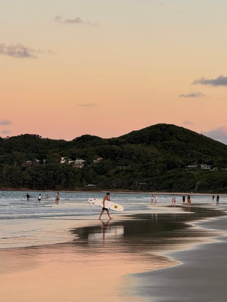 Sunset surfer at Byron Bay, coastal Australia launch imagery