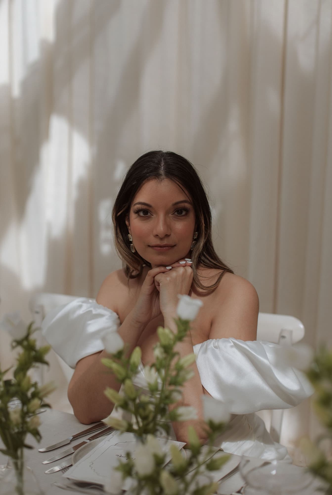 Styled bridal portrait, bride at a table with white florals