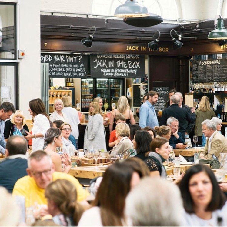 Inside Altrincham Market on a busy day, packed with diners and drinkers.