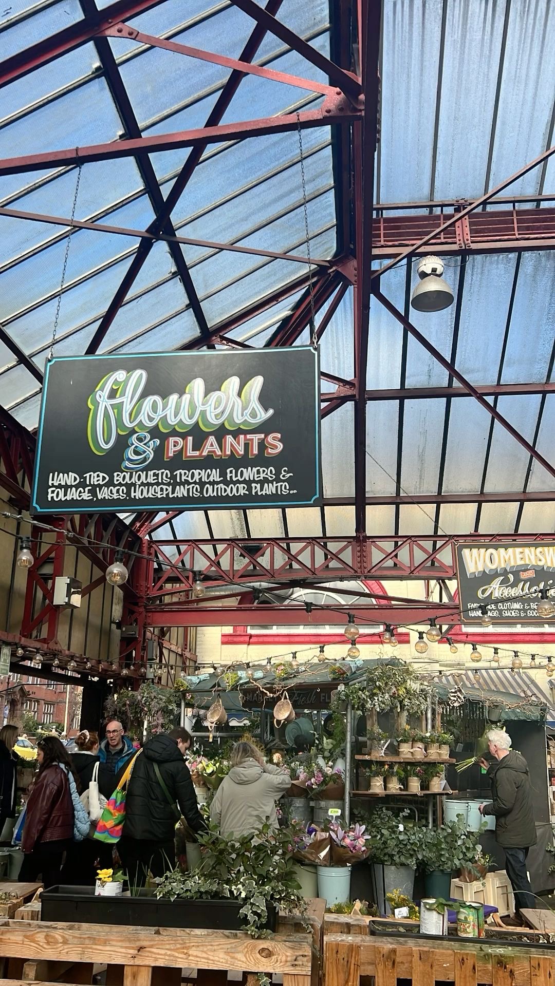 A flower and plants stall inside the Altrincham Market hall.
