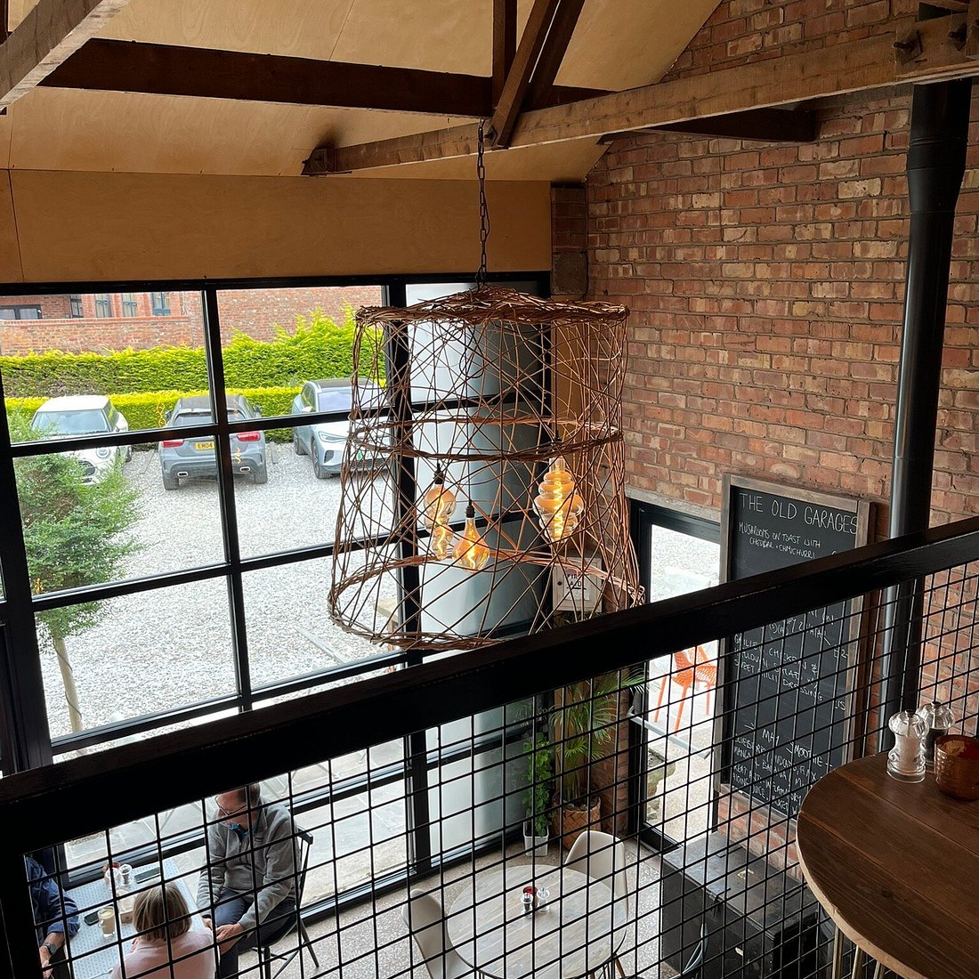 A coffee shop interior in Wilmslow, looking down from a mezzanine onto the courtyard.
